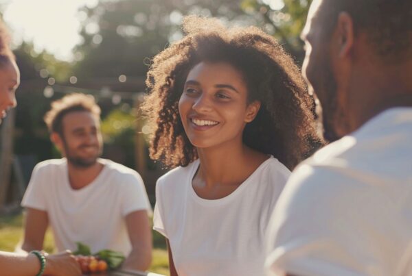 People sitting together outside talking and supporting each other during a discussion about what is group therapy.